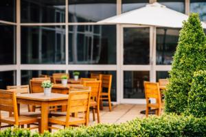 a patio with tables and chairs in front of a building at Holiday Inn Southampton, an IHG Hotel in Southampton