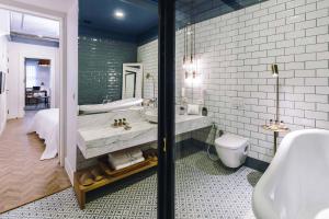 a bathroom with a tub and a sink and a toilet at The Soul Istanbul Hotel in Istanbul