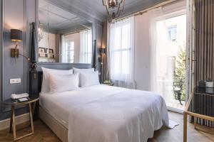 a bedroom with a large white bed and a window at The Soul Istanbul Hotel in Istanbul