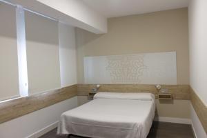 מיטה או מיטות בחדר ב-Deluxe Hostels & Suites Merida