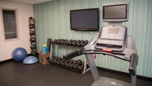 a room with a gym with a treadmill and a tv at Holiday Inn Express & Suites Colorado Springs North, an IHG Hotel in Colorado Springs