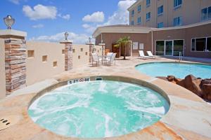 - une piscine sur une terrasse à côté d'un bâtiment dans l'établissement Holiday Inn Express Houston Space Center-Clear Lake by IHG, à Webster