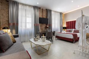 Кровать или кровати в номере BiBo Suites Plaza Nueva