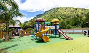 a playground with a slide and a slideintend at Rainforest Resort and Spa, Igatpuri -Nature's Luxury Awaits in Igatpuri