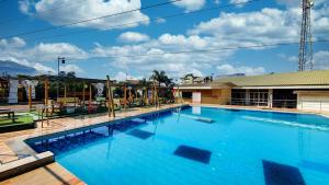 a large swimming pool with blue water at Rainforest Resort and Spa, Igatpuri -Nature's Luxury Awaits in Igatpuri