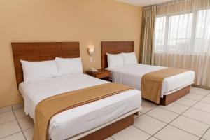 Costa del Sol Wyndham Pucallpa में एक कमरे में एक या कई बेड