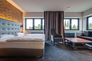 Кровать или кровати в номере Park Inn by Radisson Lübeck