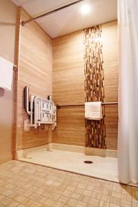 a bathroom with a shower with a shower curtain at Holiday Inn Express and Suites Calgary University, an IHG Hotel in Calgary