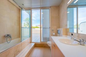 a bathroom with a sink and a toilet and a window at InSitges Sant Sebastia's Beach in Sitges