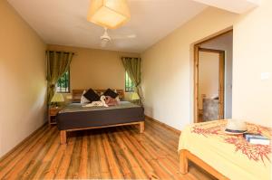 a bedroom with two beds in a room at Happy Days Guest House in Le Morne