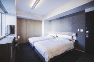 Un pat sau paturi într-o cameră la Hotel Kajiwara