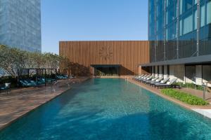 a swimming pool in the middle of a building at Carlton Hotel Bangkok Sukhumvit in Bangkok