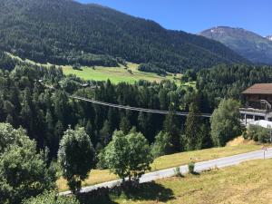 a road in a valley with trees and a mountain w obiekcie Hotel Haus Mühlebach w mieście Ernen