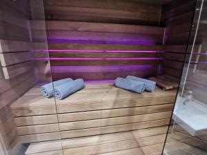 una sauna con 2 toallas en el suelo de madera en Jacuzzi Apartments, en Cracovia