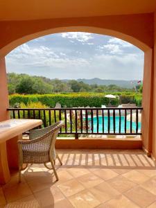 a balcony with a table and a view of the water at Green Park Hotel in Porto Cervo