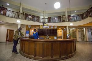 un homme et une femme debout dans un bar d'un bâtiment dans l'établissement Sirikwa Hotel, à Eldoret