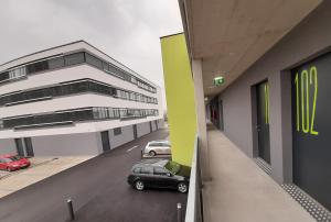 a car parked in a parking lot next to a building at Office Base Bad Vöslau MOTEL in Bad Vöslau