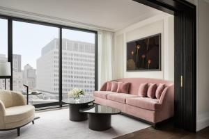 salon z różową kanapą i dużym oknem w obiekcie Four Seasons Hotel Montreal w Montrealu