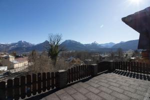 a fence with mountains in the background at Haus Bergland in St. Wolfgang