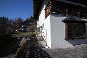 a building with a fence and shadows on the side of it at Haus Bergland in St. Wolfgang