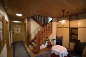 a hallway with a staircase in a house with a table at Haus Bergland in St. Wolfgang