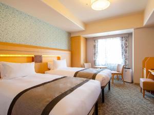 Giường trong phòng chung tại Hotel Monterey Kobe