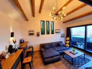 a living room with a couch and a table at Bagoly Wellness Apartman in Pécs