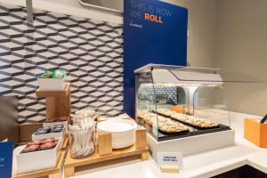 a display case with donuts and other pastries at Holiday Inn Express & Suites Tell City, an IHG Hotel in Tell City