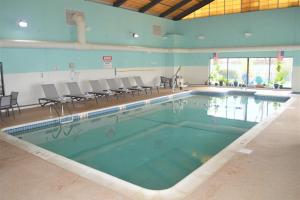 a large swimming pool with chairs in a building at Falmouth Inn in Falmouth