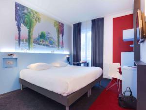 Rúm í herbergi á ibis Styles Nantes Centre Gare