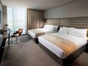 Cama ou camas em um quarto em Pullman Brisbane Airport