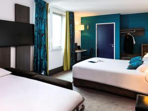 Giường trong phòng chung tại Ibis Styles Lyon Centre - Gare Part Dieu