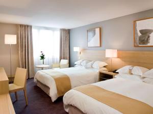 Кровать или кровати в номере Mercure Paris Velizy