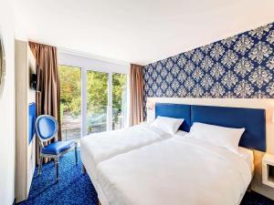 سرير أو أسرّة في غرفة في ibis Styles Rastatt Baden-Baden