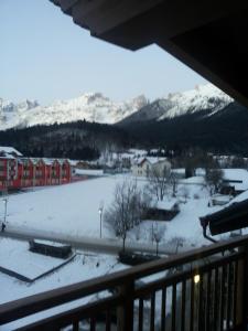 a view of a snow covered field from a balcony at Appartamento Mariastella in Andalo