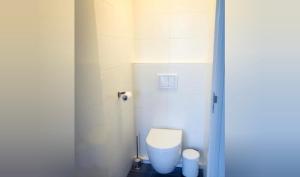 a bathroom with a white toilet in a stall at Queens Beachhouse in Zandvoort