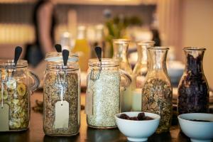 a table topped with jars filled with different types of seeds at Carina - Design&Lifestyle hotel in Zermatt