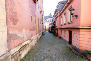 an empty alley in an old town with buildings at Hotel Havana in Mainz