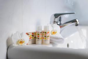 a bathroom sink with two bottles of soap and towels at Kilkenny Hibernian Hotel in Kilkenny