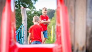 two young boys are standing in a play structure at Gästehaus Ranftl in Unterlamm