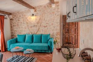 a living room with a blue couch and two tables at Apartments Bazar in Ulcinj