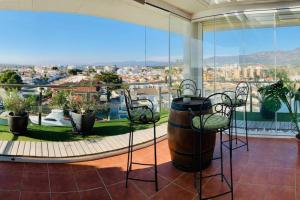 a balcony with chairs and a view of a city at Les Marines in Roses