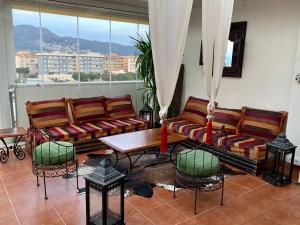 a living room with two couches and a table at Les Marines in Roses