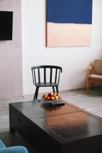 a coffee table with a bowl of fruit on top of it at Artists Residence Liepāja in Liepāja