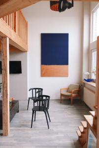 a living room with two chairs and a couch at Artists Residence Liepāja in Liepāja