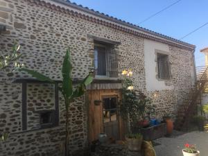 una casa in pietra con una porta in legno in un cortile di Ô Joly Valois a Hauterives