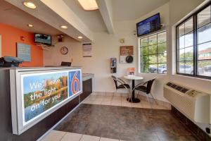 a waiting room with a television and a small table at Motel 6-Wethersfield, CT - Hartford in Wethersfield