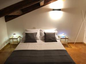 a bedroom with a large bed with two side tables at Residenza Privata Pedrotti in Vicenza