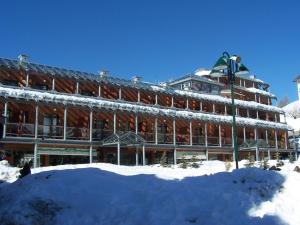 a large building with snow in front of it at Il Fraitevino hotel bed & breakfast in Sestriere