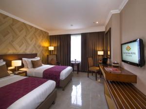 Lova arba lovos apgyvendinimo įstaigoje The Victoria Hotel Yogyakarta